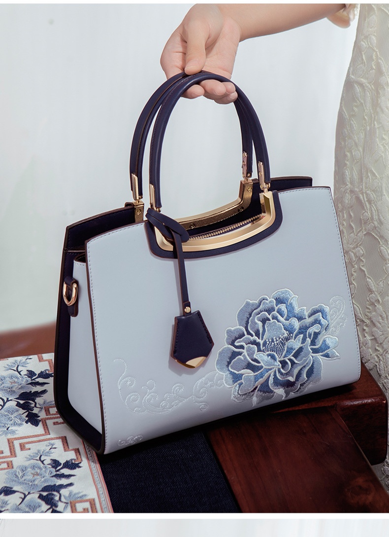 Ladies Elegant Burgundy Handbag with Floral Embroidery And Gold-Tone Hardware